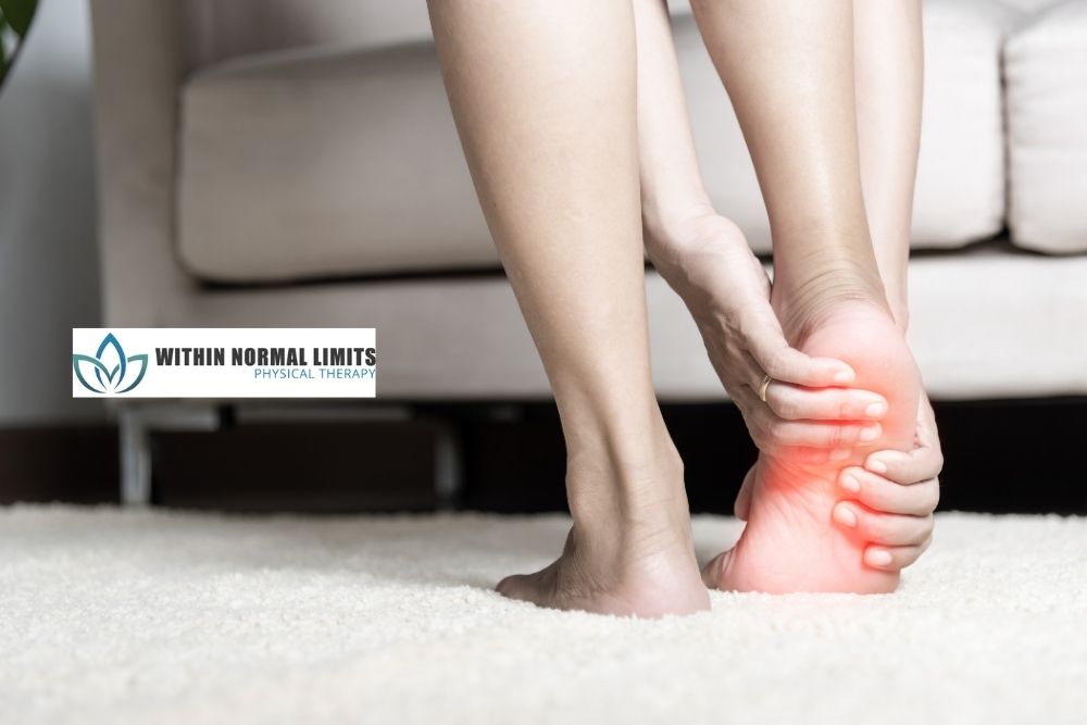 A person holds their heel in apparent pain, highlighting the area in red; a logo for "Within Normal Limits Physical Therapy" is visible in the background.